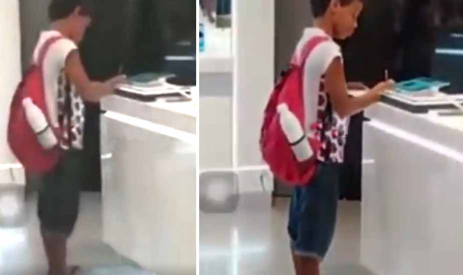 Isang batang gumagawa ng kaniyang homework sa loob ng isang gadget store hinangaan ng publiko!